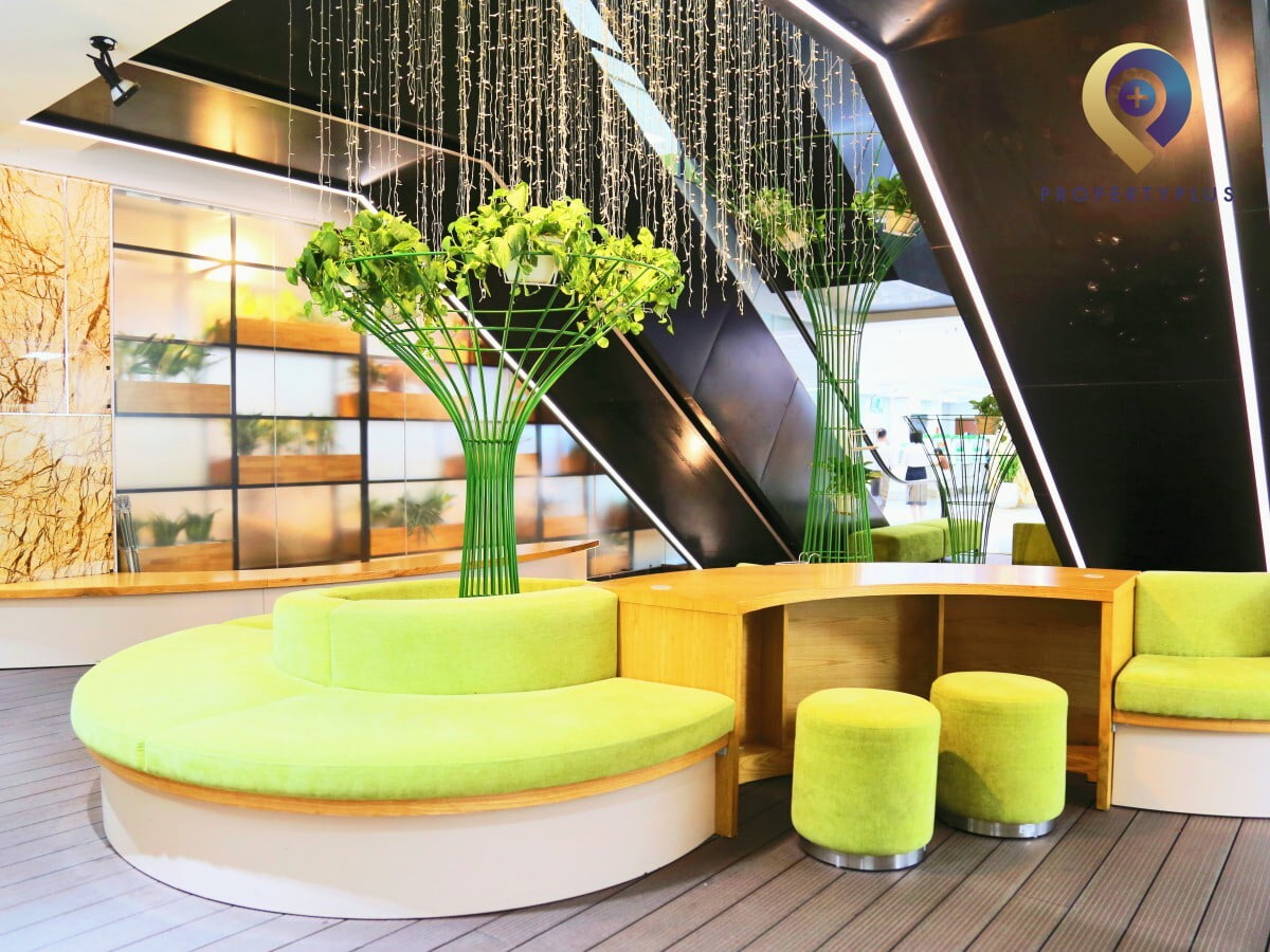 Modern lobby area with green seating and decorative lighting at Hapro Building - hình ảnh từ Property Plus